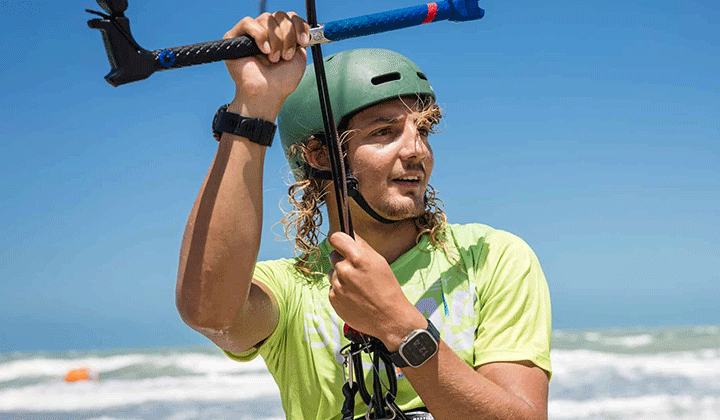 Kite freestyle athlete riding a wave